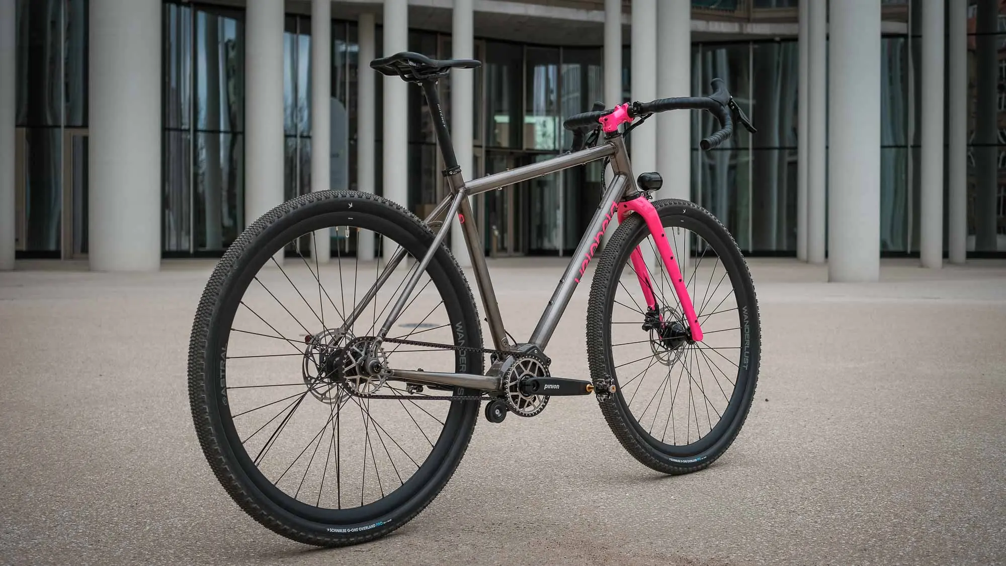 veloheld iconX Pinion Custom Gravelbike mit Riemenantrieb und pinker Gabel